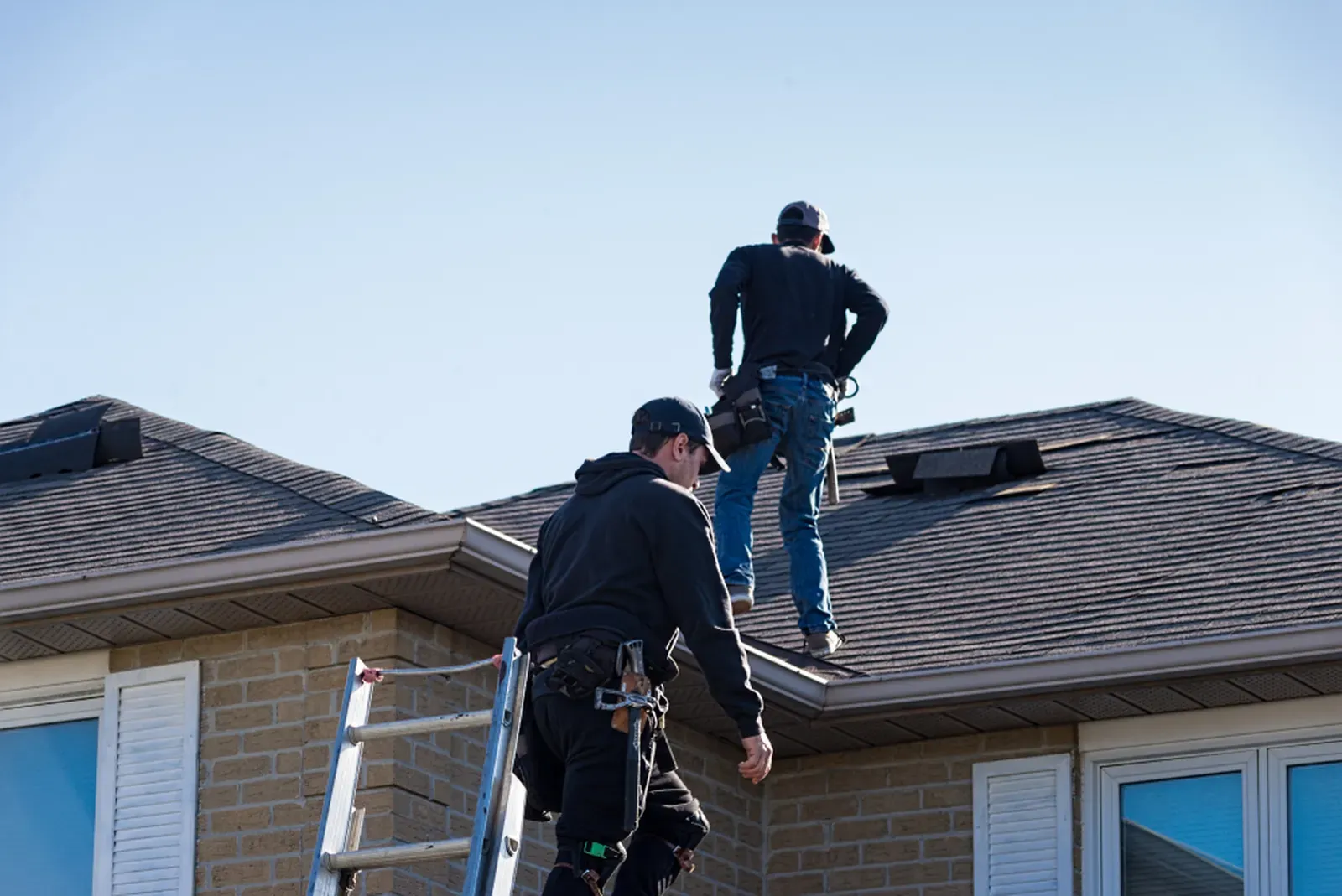 An image of a residential asphalt roof being repaired with hero-approved materials. | You First Home Services