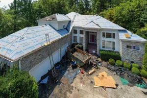 An unprocessed image of a damaged roof needing service after a storm | You First Home Services