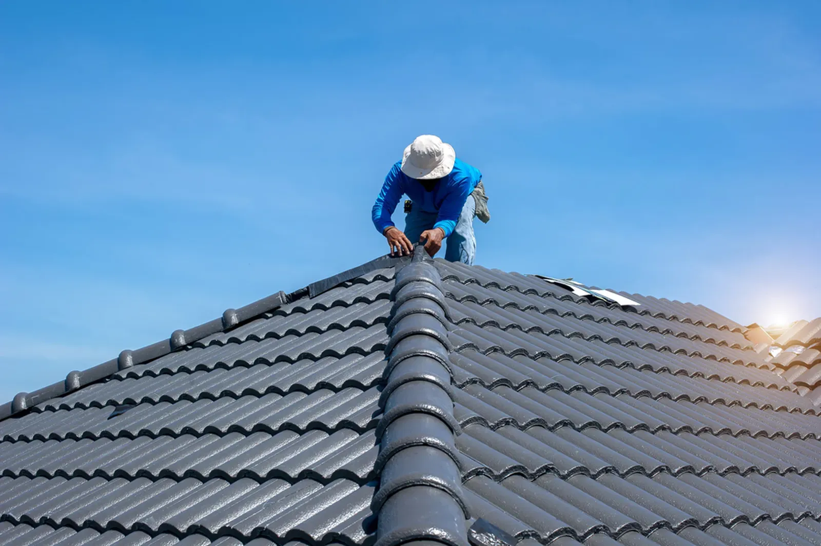 A residential roof with tile, undergoing repair. | You First Home Services