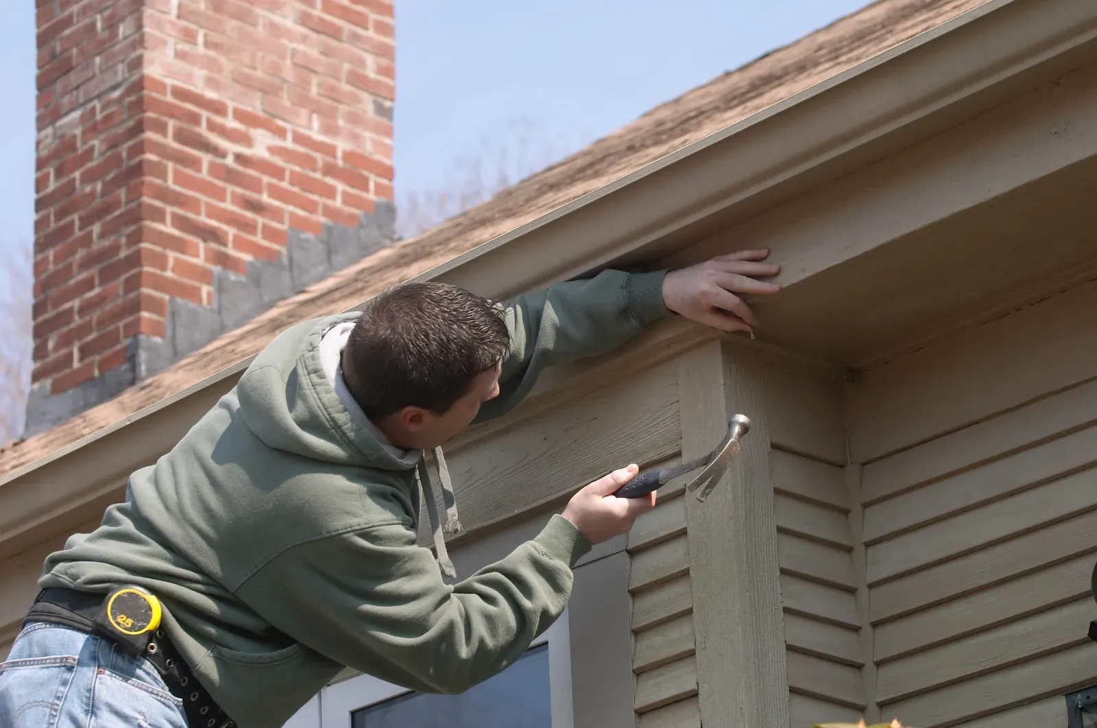 "Image of a vinyl siding repair being done on a residential building" | You First Home Services