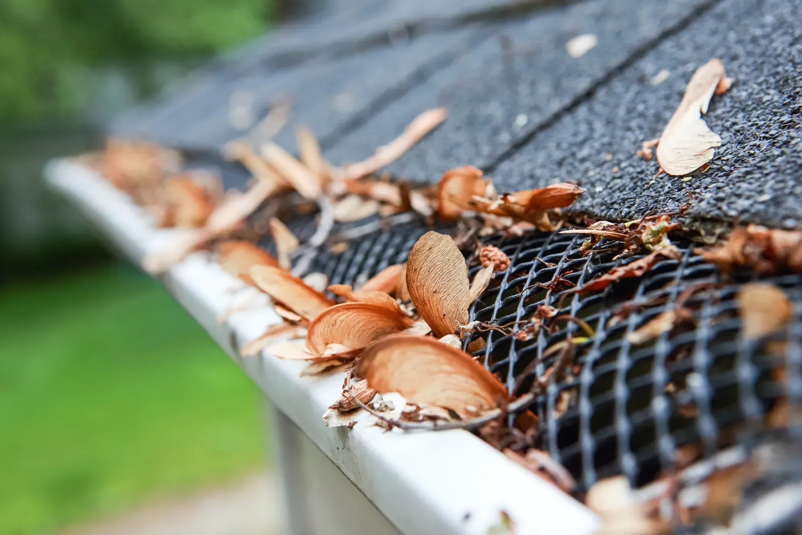 A newly installed residential gutter being repaired and replaced with gutter guards. | You First Home Services