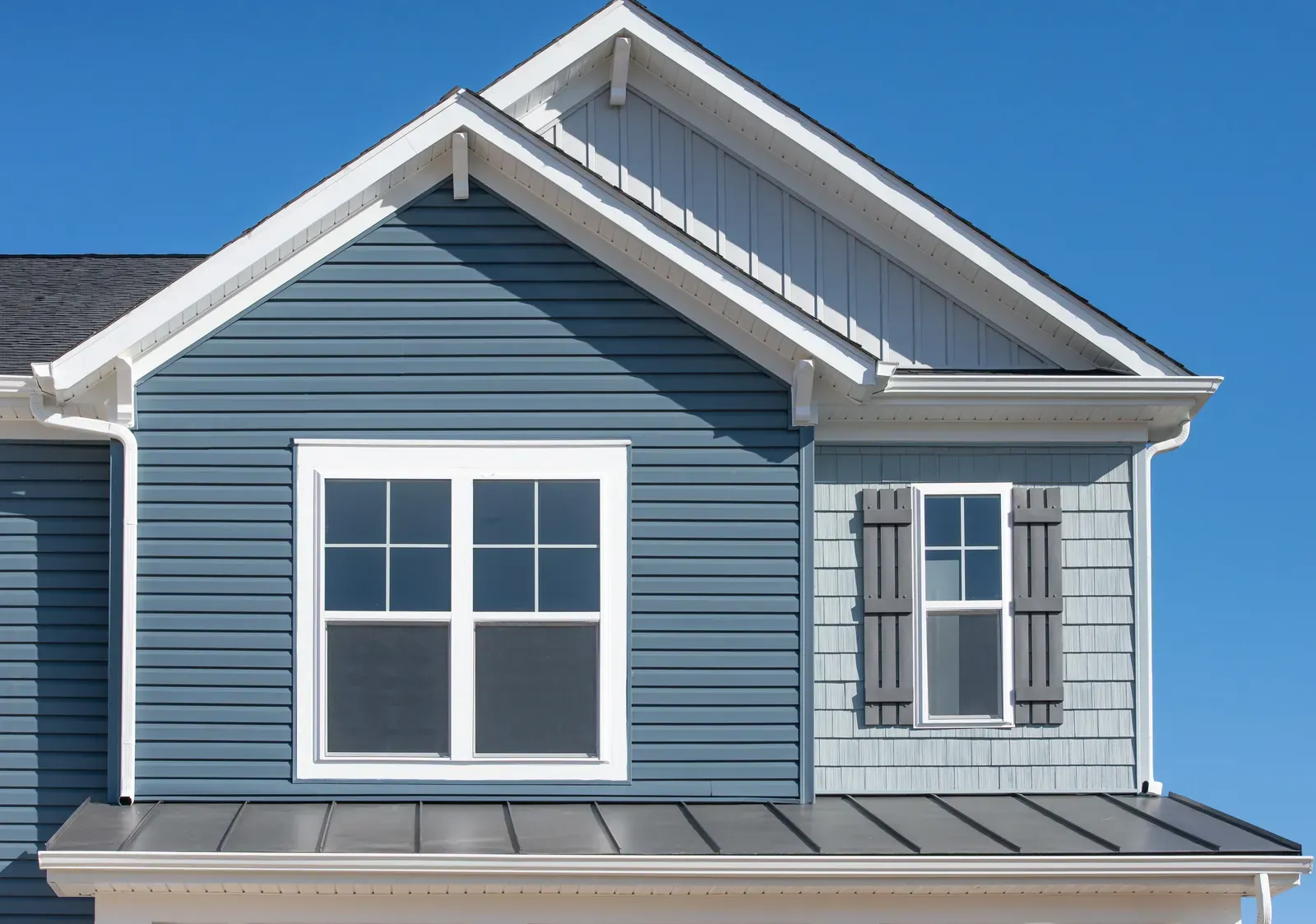 A professional crew installing new shake-style siding on a residential home. | You First Home Services