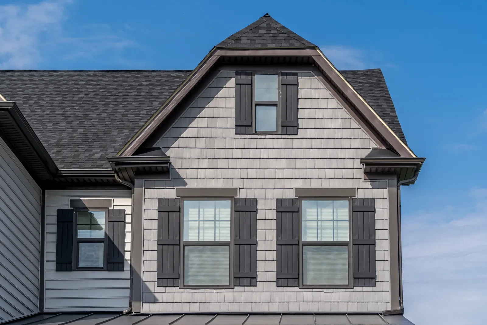 A professional contractor replacing and installing high-quality shake siding on a residential property, approved by a hero feature. | You First Home Services