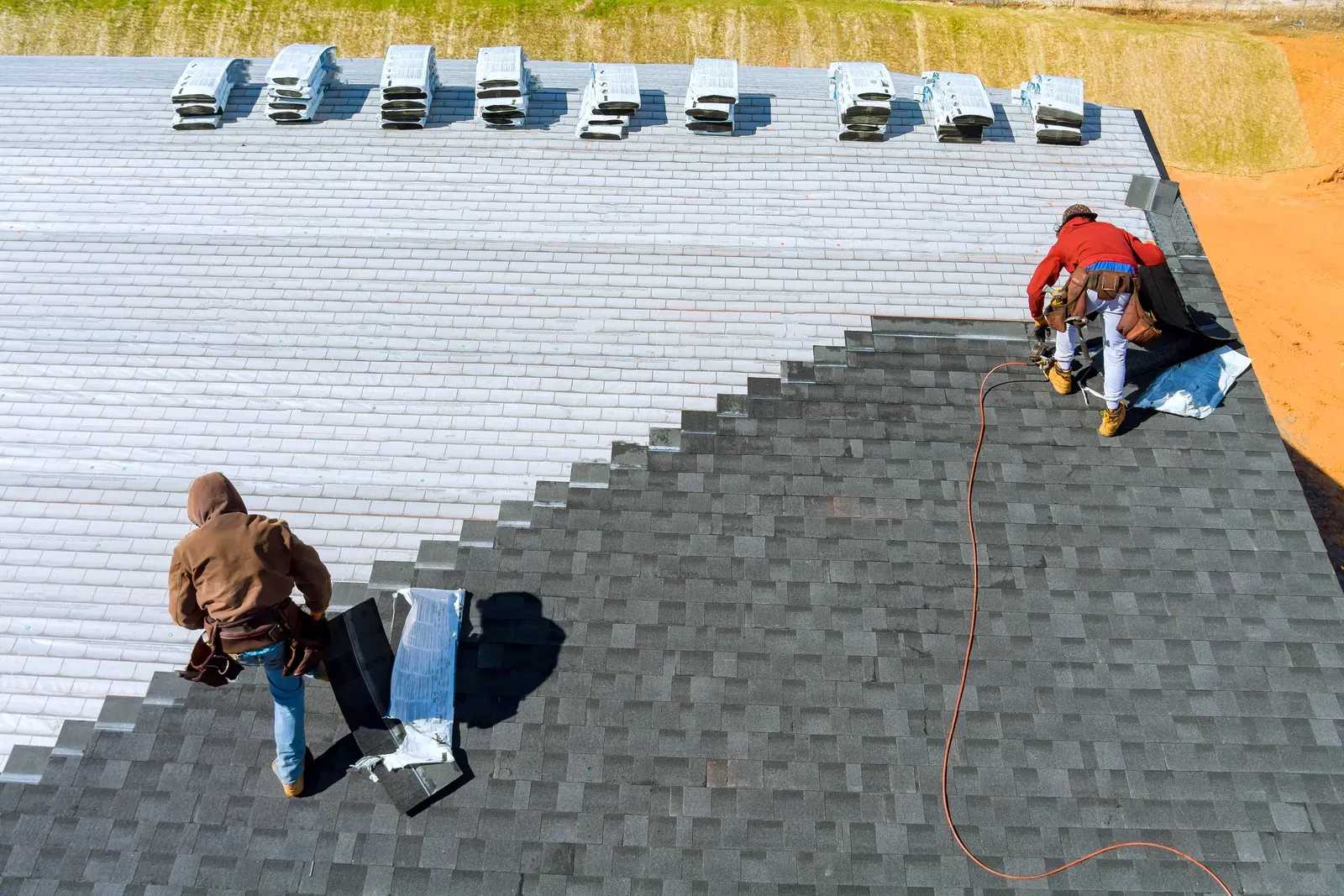 A newly replaced asphalt roof on a residential building, hero-approved. | You First Home Services