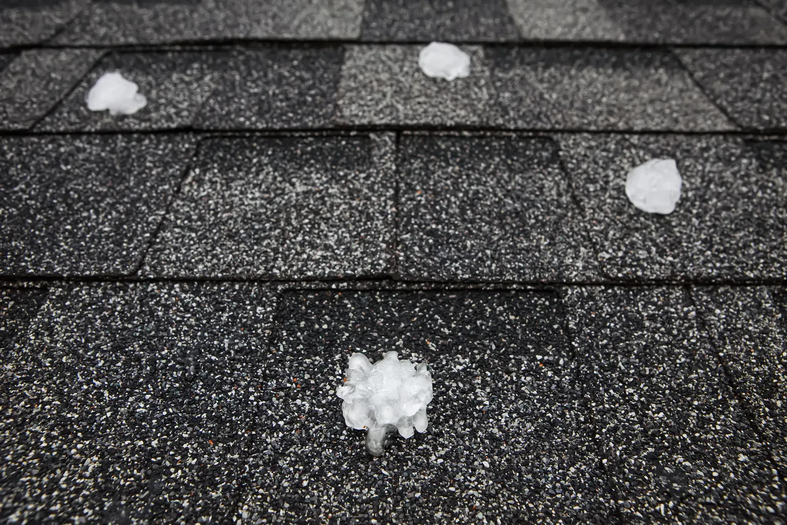 A photo of a damaged roof with storm damage, in need of service. | You First Home Services