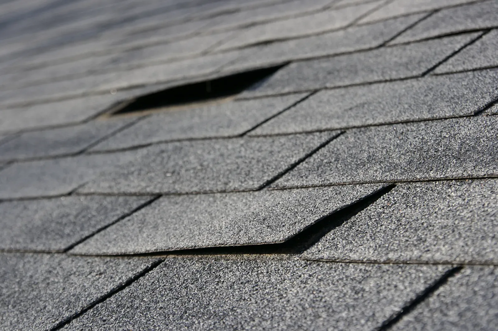 A photo of a residential asphalt roof under repair, labeled as hero-approved. | You First Home Services