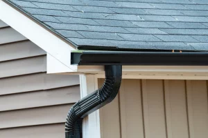 A newly installed aluminum residential gutter being repaired or replaced. | You First Home Services