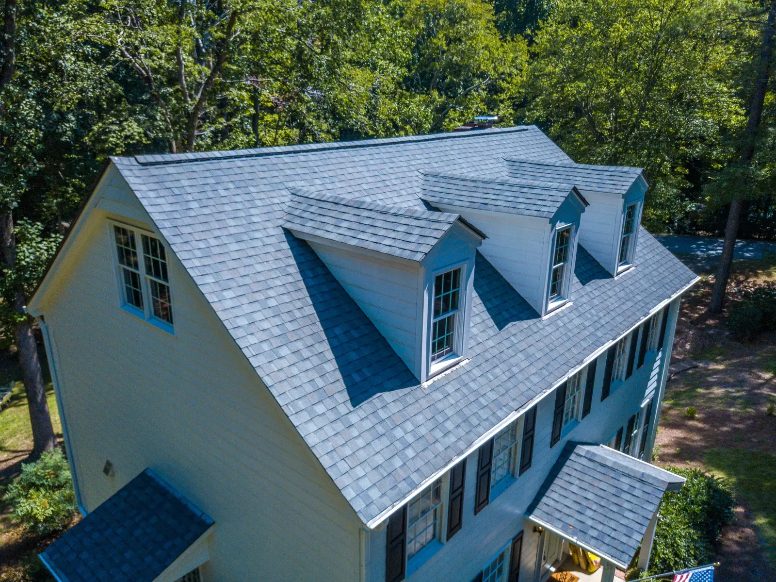 An image of a residential asphalt roof being replaced, viewed from a hero-approved perspective. | You First Home Services