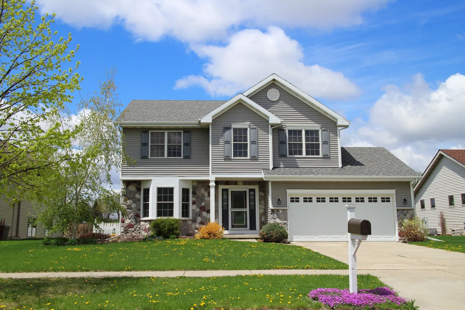 A new vinyl siding being installed on a residential property. | You First Home Services